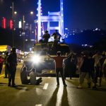 People take over a tank near the Fatih Sultan Mehmet bridge during clashes with military forces in Istanbul on July 16, 2016. 
Istanbul's bridges across the Bosphorus, the strait separating the European and Asian sides of the city, have been closed to traffic. Turkish military forces on July 16 opened fire on crowds gathered in Istanbul following a coup attempt, causing casualties, an AFP photographer said. The soldiers opened fire on grounds around the first bridge across the Bosphorus dividing Europe and Asia, said the photographer, who saw wounded people being taken to ambulances.
 / AFP PHOTO / GURCAN OZTURKGURCAN OZTURK/AFP/Getty Images