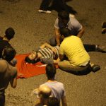 epa05427192 People attend to a wounded person in Ankara, Turkey, 16 July 2016. Turkish Prime Minister Yildirim reportedly said that the Turkish military was involved in an attempted coup d'etat. The Turkish military meanwhile stated it had taken over control.  EPA/STR